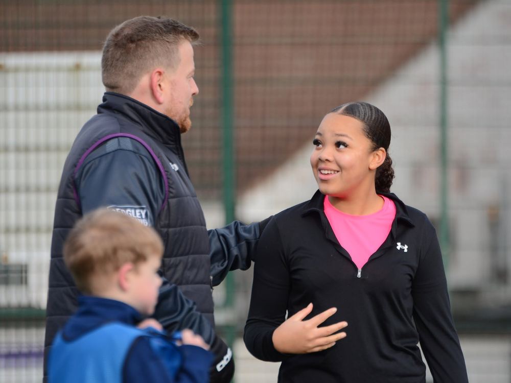 M11 Football Coaching coaches encouraging a young player during a session