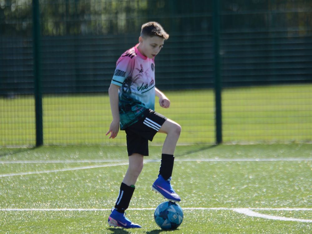 A young player working on his dribbling during 1-to-1 football coaching in Dudley
